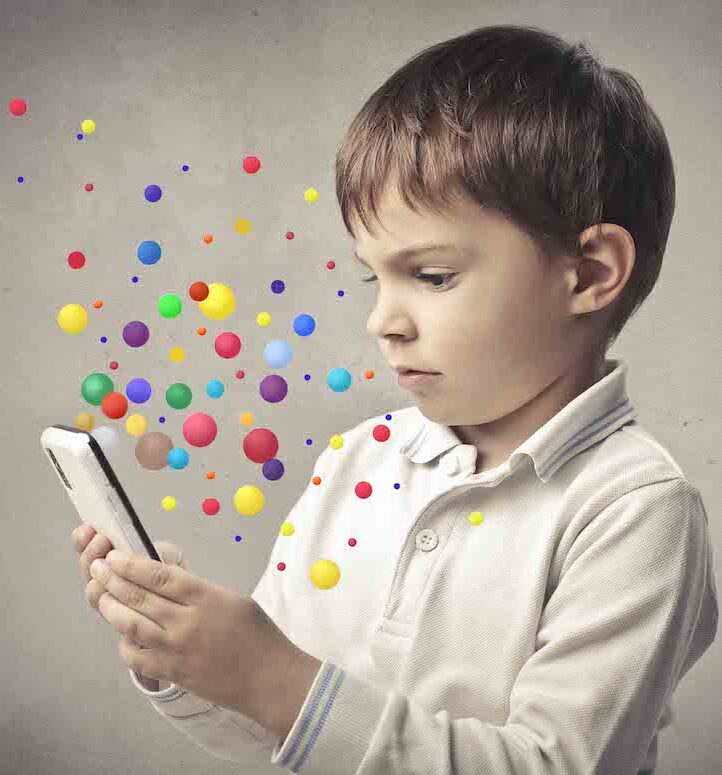 boy-with-phone small boy looking at a phone with coloured bubbles around