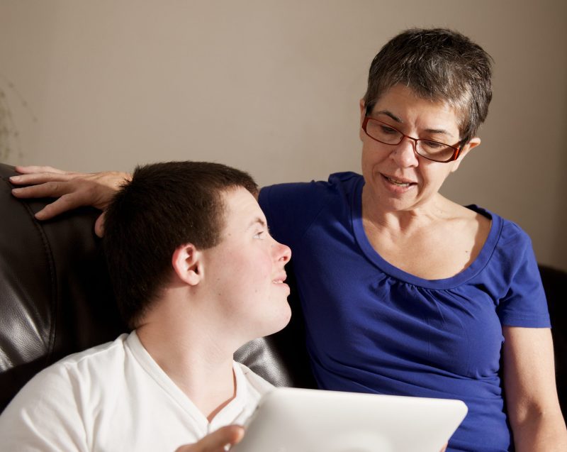 Mother and her sixteen year old son with a disability Mother with her sixteen year old son with a disability.