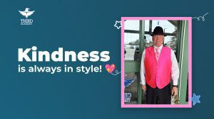 Wayne Capper, an InBus driver for Third Academy, smiling warmly while wearing a professional pink vest and matching pink tie in honor of Pink Shirt Day 2026.